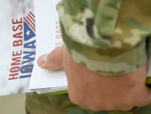 soldier's hand holding HBI brochure