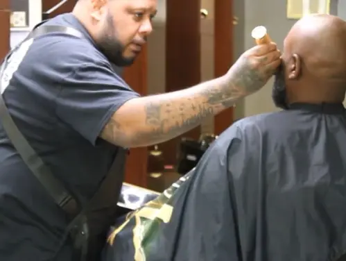 Cassii working on a client's facial hair