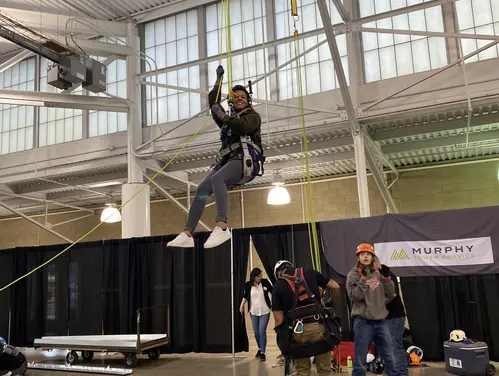 woman trying out pulley system set up by business