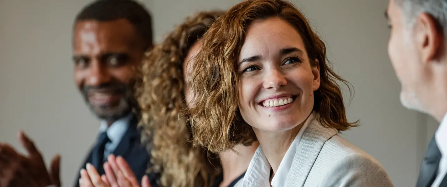 Woman Smiling at Business Meeting