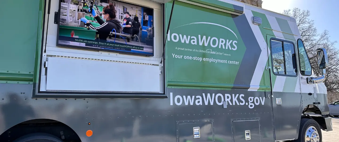 Photo of the Mobile Workforce Center with a TV playing a workforce video.