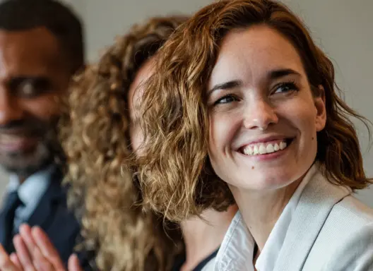 Woman Smiling at Business Meeting