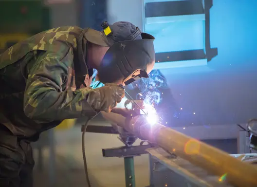 This image shows a service member in a welding occupation.