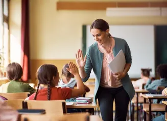 Teacher Helping a Student in the Classroom