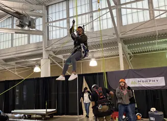 woman trying out pulley system set up by business