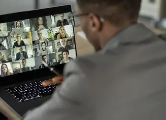 Man attending virtual meeting on laptop