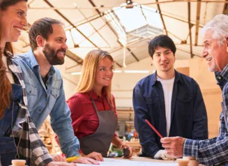 A work-based learning situation where an older individual is instructing students in the workplace