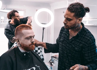 Jake Sahr giving a haircut.