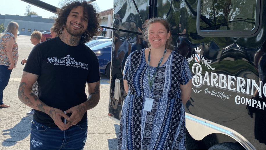 A program participant in the Pre-Employment Transition Services program poses for a photo with a business leader. This was during the "Shark Tank" portion of the program where participants create business ideas and share them with business leaders.